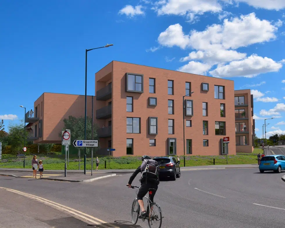 Modern apartment building by cyclists and vehicles.