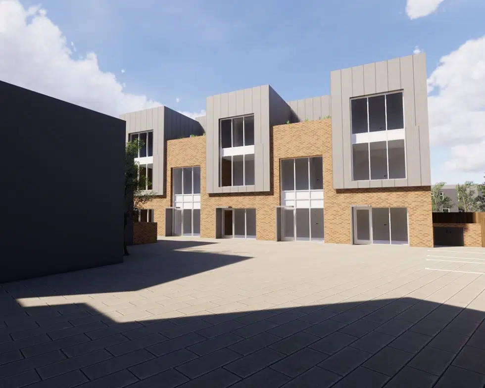 Modern brick building with large windows and courtyard.